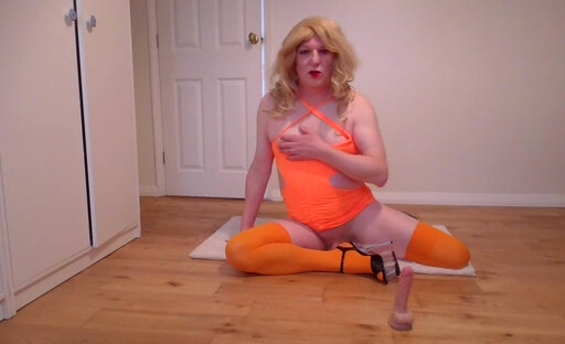 Orange minidress, stockings and dildo