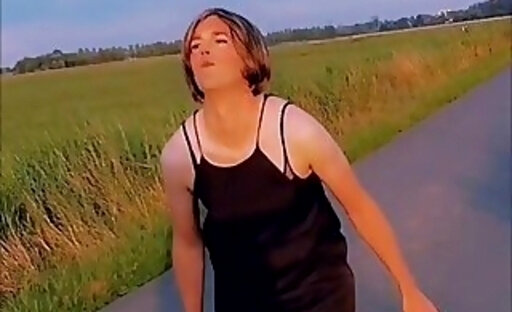 Annemieke in summer dress flashing on a road