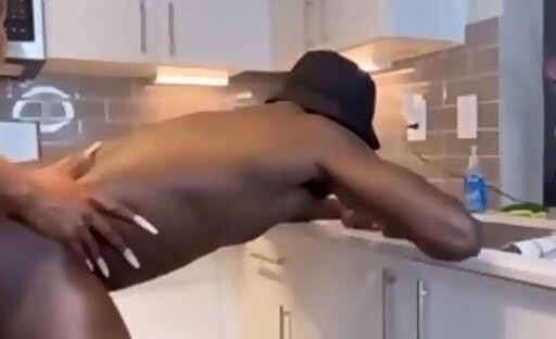 Busty ebony shemale humiliates a dude's ass in the kitchen