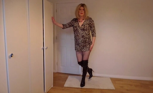 Sissy blonde in leopard print dress, fishnets and latex boots