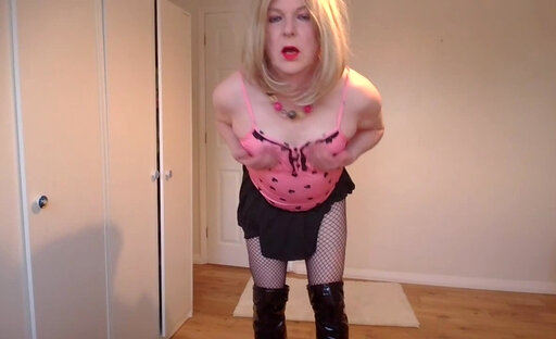Pink top, black miniskirt and fishnets