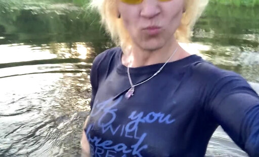 Transgirl Alexa Cosmic soaking and swimming in denim shorts and top and nude in the lake