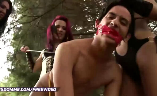 Three shemale dominas in black lingerie fuck a dude outdoors