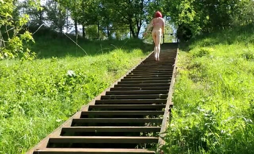 Naked sissy on the stairs