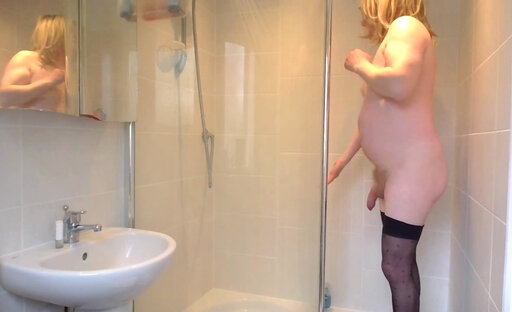 Taking a shower in black stockings and orange bikini